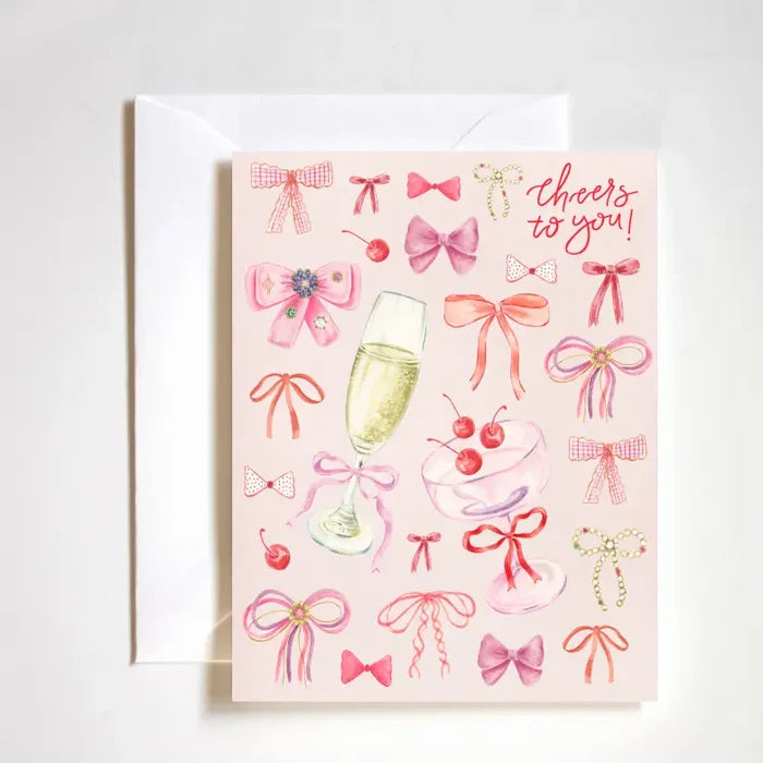 "Coquette Cheers Card" – Feminine A2 congratulations card with hand-drawn bows and luxe finish

"Bows & Congrats Card" – Girly celebration card featuring coquette-style artwork

"Cheers to You Stationery" – Playful and elegant card perfect for congratulating with style