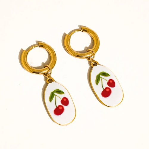 “Cherry Gold Dangles” – Close-up of vintage cherry earrings against a blush fabric background

“Sweet Retro Earrings” – Earrings styled next to red lipstick and heart sunglasses