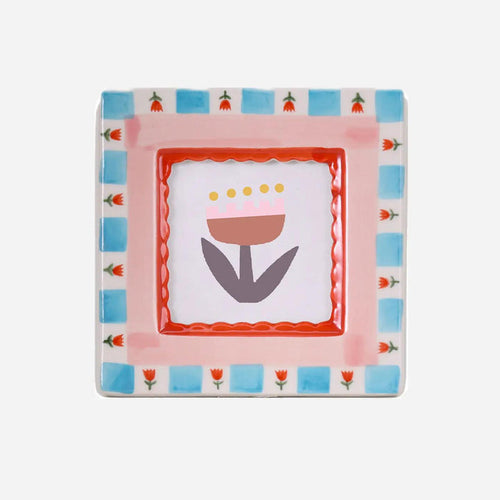 “Hand-painted ceramic photo frame with red flower patterns on a white base.”

“Close-up of a red floral ceramic frame holding a small photograph on a wooden table.”

“Decorative red flower photo frame surrounded by petals and soft light.”